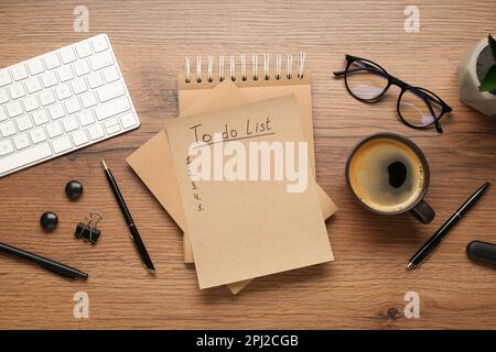 Flat lay composition with unfilled To Do list, cup of coffee and glasses on wooden table Stock Photo