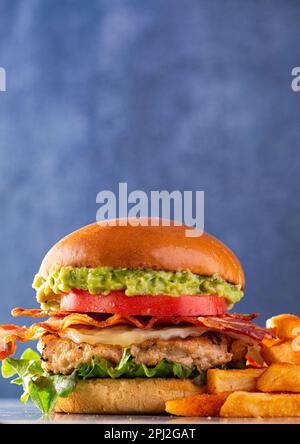 Turkey bacon burger with lettuce, tomato avocado, with a side of French fries; copy space Stock Photo