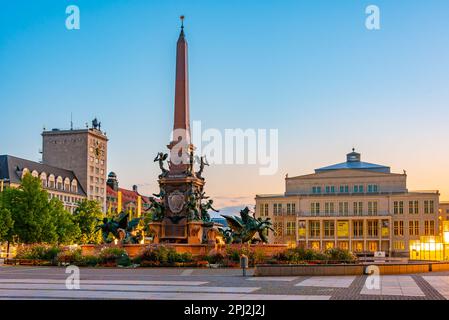 Leipzig, Germany, August 9, 2022: Sunrise over Mendebrunnen fountain and opera in German town Leipzig. Stock Photo