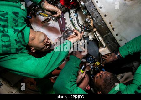 Adriatic Sea. 25th Feb, 2023. Aviation Machinists Mate Airman Kendal Cook, left, Aviation Machinists Mate 3rd Class James Barclift, right, and Aviation Machinists Mate 1st Class David Carlile, all assigned to Strike Fighter Squadron (VFA) 143, perform maintenance on an air turbine starter aboard the Nimitz-class aircraft carrier USS George H.W. Bush (CVN 77) Credit: U.S. Navy/ZUMA Press Wire Service/ZUMAPRESS.com/Alamy Live News Stock Photo