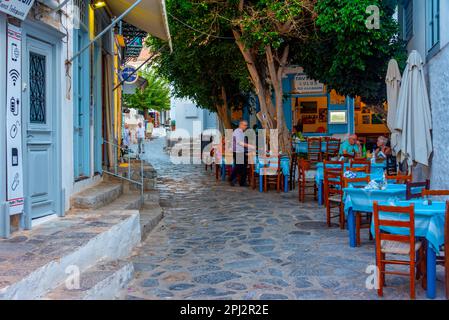 Hydra, Greece, September 4, 2022: Sunset view of a street of Greek town Hydra. Stock Photo