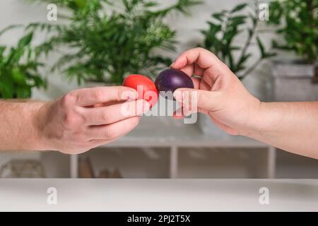 Two people are beating Easter eggs. A tradition for Easter. Stock Photo