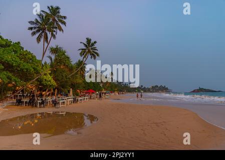 Mirissa, Sri Lanka, January 22, 2022: Sunset view of a beach restaurant at Mirissa beach, Sri Lanka. Stock Photo