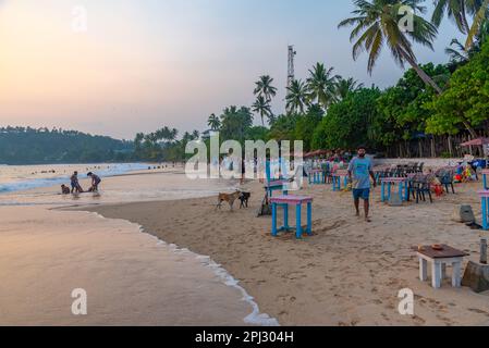 Mirissa, Sri Lanka, January 22, 2022: Sunset view of a beach restaurant at Mirissa beach, Sri Lanka. Stock Photo