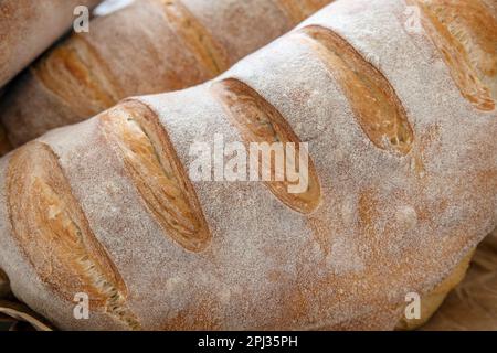 Close-up of a freshly baked sourdough bread showing a healthy golden crust, artisanal loaves leavened through a natural fermentation process Stock Photo