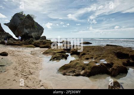 The Suluban beach in Bali, Indonesia, with rough rocks in the foreground. Stock Photo