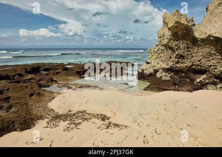 The Suluban beach in Bali, Indonesia, with rough rocks on the right. Stock Photo