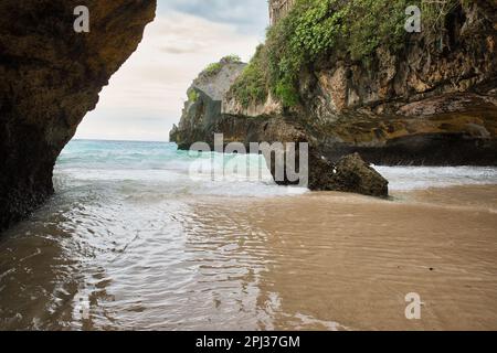 The Suluban beach in Bali, Indonesia, enclosed in a bay of majestic rocks. Stock Photo