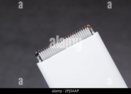 Closeup macro of the ceramic cutting blade of a white hair clipper, object isolated on dark background. Stock Photo