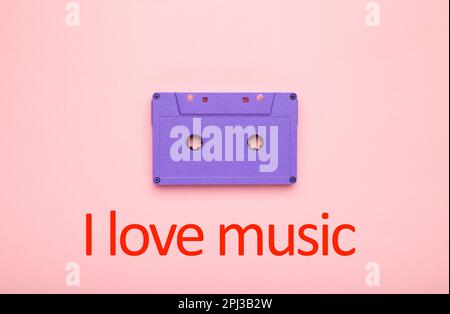 Inscription I love music with old colorful cassette on a pink background. Music day Stock Photo