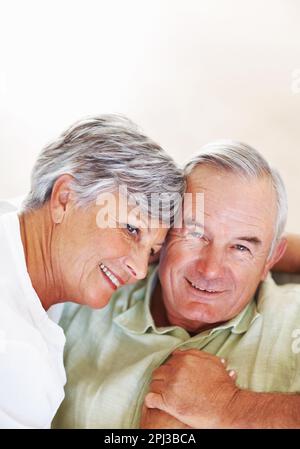 Mature couple spending romantic time together. Smiling mature couple spending romantic time together at home. Stock Photo