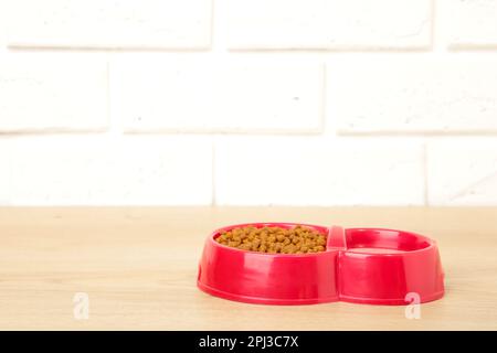 Red pet bowl on the light background. Top view Stock Photo