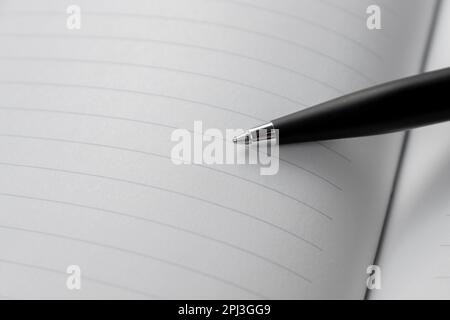 A pen placed on opened page of a book. After some edits. Stock Photo