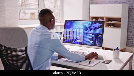 African American Data Analyst Using Data Analytics KPI Dashboard Stock Photo
