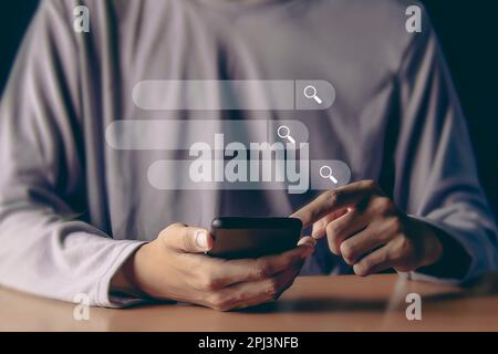 Searching the internet with a search bar working on a smartphone, internet network concept. Stock Photo