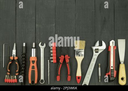 Tools on a rustic background with copy space. Working tools on a wooden rustic background. view from above Stock Photo