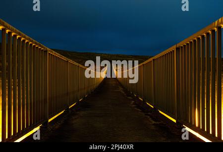 Pennine Way footbridge over the M62 motorway at night. Close to the border between Yorkshire and Lancashire and Windy Hill and Saddleworth Moor Stock Photo