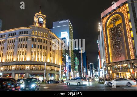 Exterior view at night of Wako and Mitsukoshi department stores in Ginza, Tokyo, Japan Stock Photo