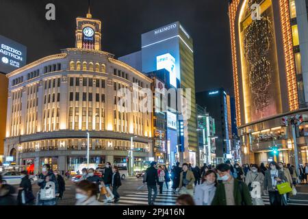 Exterior view at night of Wako and Mitsukoshi department stores in Ginza, Tokyo, Japan Stock Photo