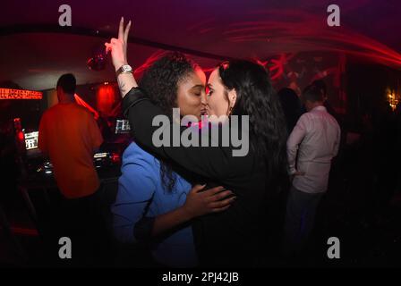 Munich, Germany. 27th Jan, 2023. Guests Seynabou Dieng (l) and Sarah Gehring kiss at the Filmkasino on Odeonsplatz. Gehring is known from the first season of the show Bachelor. Credit: Felix Hörhager/dpa/Alamy Live News Stock Photo