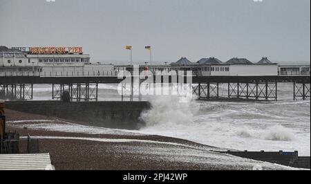 Brighton UK 31st March 2023 - Waves crash on to Brighton beach early this morning as Storm Mathis batters the South Coast today with winds forecast to reach 70mph in some areas : Credit Simon Dack / Alamy Live News Stock Photo