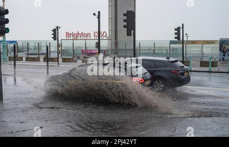 Brighton UK 31st March 2023 - Drivers head through the flooded Brighton seafront road early this morning as Storm Mathis batters the South Coast today with winds forecast to reach 70mph in some areas : Credit Simon Dack / Alamy Live News Stock Photo