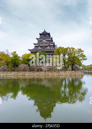 Exterior view of Hiroshima Castle in cherry blossom season, Hiroshima , Japan Stock Photo