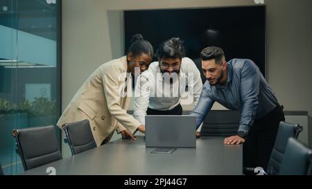 Diverse business partners colleagues people multiracial corporate group project team African woman and Indian Arabian men online work with laptop Stock Photo