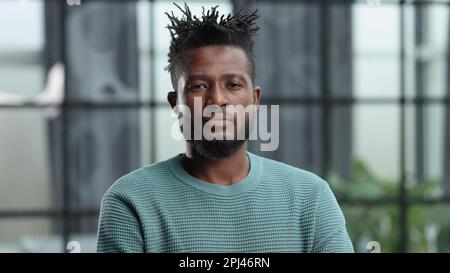 Thoughtful young black man looking straight ahead Stock Photo
