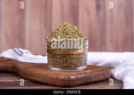 Thyme spice. Dried Thyme leaf in glass bowl on wood floor. Spice concept. Stock Photo