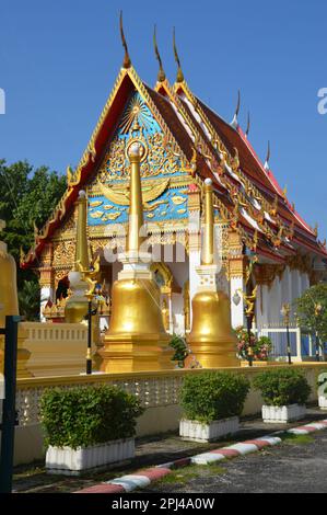 Thailand, Phuket Island, Phuket City:  Wat Phuttha Mongkhon Nimit Buddhist Temple with golden stupas in the foreground. Stock Photo