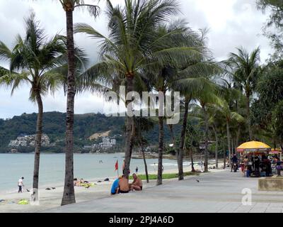 Thailand, Phuket Island, Patong Beach:    the palm-tree-lined promenade, sandy beach, and hotels on the far side of the bay. Stock Photo