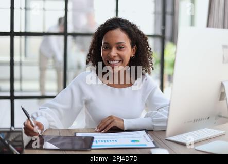 woman in eyewear planning working schedule writing in notebook w Stock Photo
