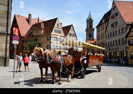 Germany, Bavaria, Mittelfranken, Dinkelsbühl: a horse-drawn carriage taking visitors through the Market Place. Stock Photo