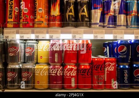 Moscow, Russia. 28th Mar, 2023. Imported Coca-Cola and Pepsi cans are seen on the shelves of a Moscow upper class grocery store Azbuka Vkusa. Although some of these beverage making companies stopped imports to Russia in 2022, their products have been imported to the country via parallel import through third countries, particularly from Denmark, Turkey, Germany, and Poland. Credit: SOPA Images Limited/Alamy Live News Stock Photo