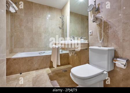 Hospital bathroom finished in marble. Shower, lavatory, wash hand basin Stock Photo