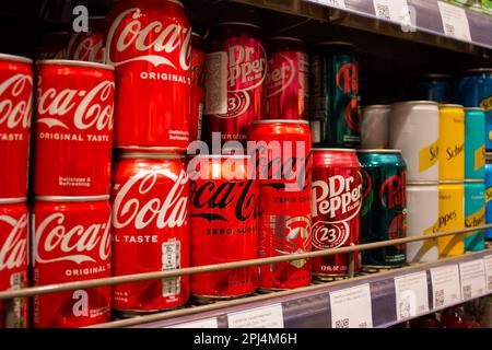 Moscow, Russia. 28th Mar, 2023. Imported Coca-Cola cans are seen on the shelves of a Moscow upper class grocery store Azbuka Vkusa. Although some of these beverage making companies stopped imports to Russia in 2022, their products have been imported to the country via parallel import through third countries, particularly from Denmark, Turkey, Germany, and Poland. (Credit Image: © Vlad Karkov/SOPA Images via ZUMA Press Wire) EDITORIAL USAGE ONLY! Not for Commercial USAGE! Stock Photo