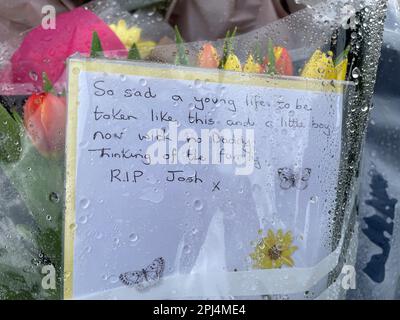 Flowers and messages left for the victim at the scene in Meridian Close, Bluntisham, Cambridgeshire. Police found the body of the 32-year-old, named locally as Josh Dunmore, with a gunshot wound on Wednesday evening. They were later called to a second property in in Sutton, where they found the body of a 57-year-old, named locally as Josh's father Gary Dunmore, who had also died from gunshot wounds. The deaths of both men are being treated as murder and three men have been arrested by Cambridgeshire Police. Picture date: Friday March 31, 2023. Stock Photo