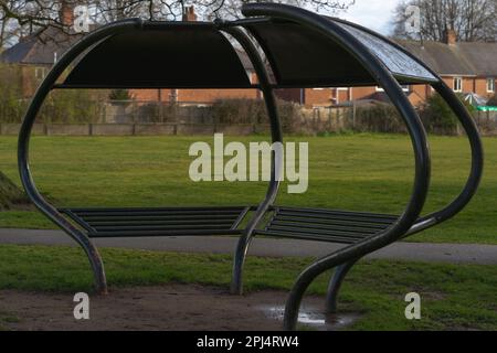 St Helens Church . Boultham Park Lincoln, Boultham Park, Lincoln, Lincolnshire, seating, shelter, area, park bench, picnic shelter, woodland, metal. Stock Photo