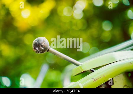 The control lever on a walk-behind tractor close-up on a blurred background. Control elements of agricultural machinery. Stock Photo