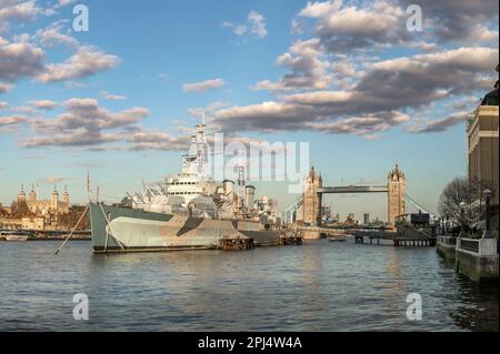 HMS Belfast moored on the River Thames alongside The Queens Walk in the Pool of London, Southwark. HMS Belfast is a Town-Class light cruiser that was Stock Photo