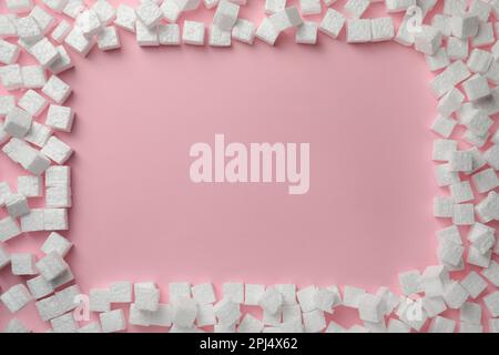 Frame made of styrofoam cubes on pink background, flat lay. Space for text Stock Photo