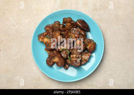 Plate with delicious kidneys and thyme on light table, top view Stock Photo