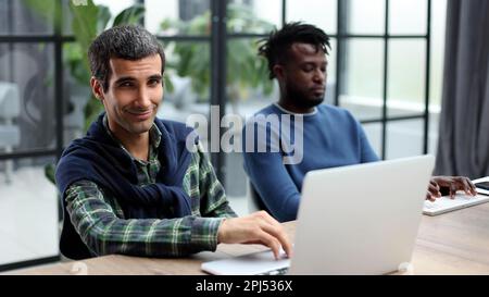 Young multiethnic businessmen working at the negotiating table Stock Photo
