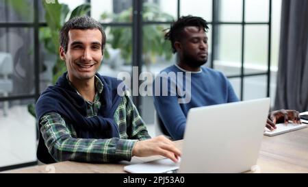 Young multiethnic businessmen working at the negotiating table Stock Photo
