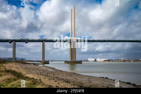 A view looking upstream on the River Thames towards the Dartford Crossing QE2 Bridge and the Purfleet Container Terminal where two roll on/roll off ca Stock Photo