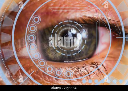 Close-up of a male eye with visual effects. The concept of a sensor implanted in the human eye. Business, computer, cyberspace. Stock Photo