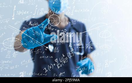 Quantitative analyst is drawing different math formulas on the glass ...