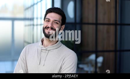 Portrait of handsome young male entrepreneur posing in office co Stock Photo