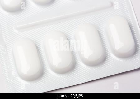 Close up of pills in white plastic blister pack Stock Photo